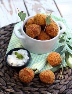 some food is in a white bowl on a wicker tablecloth and green napkin