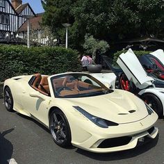 two white sports cars parked next to each other