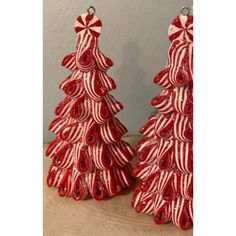 two red and white christmas trees on a table