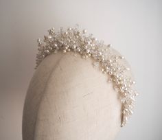 The Celine crown is crystal and freshwater pearl adorned headpiece on a fine silver band. A modern, eye-catching piece to elevate your bridal look. All pieces are designed and handmade in England, using high quality beads and embellishments, tarnish free jewellery wire and a comfortable headband base ideal for wearing over long periods of time.  LEAD TIME Made to order in 2-3 weeks, plus delivery time.  UK Delivery: 2-5 working days (Royal Mail Tracked) International Delivery: 5-10 working days (International Tracked & Signed) RUSHED ORDERS Please get in touch if you need your piece sooner. This is sometimes possible with a rushed order fee but entirely depends on the design and time frame it is needed within.  CUSTOM DESIGNS Designs can be customised to suit your hairstyle or wedding/occa Silver Headpiece, Pearl Hair Piece, Jewellery Wire, Beaded Crown, Pearl Bridal Headband, Silver Head Piece, Pearl Headpiece, Comfortable Headbands, Crown Bridal