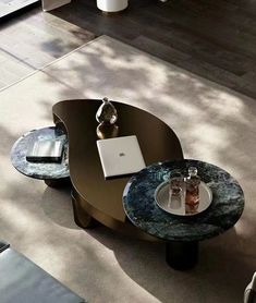 a coffee table with a laptop on it in the middle of a living room area