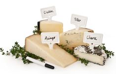 several different types of cheese with labels on them