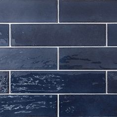 a blue brick wall with water on it