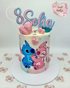 a birthday cake decorated with the characters of stitch and stitch on it's frosting