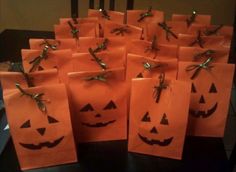 orange bags with pumpkin faces on them sitting on a table