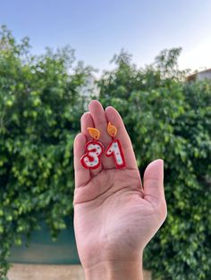 Celebrate birthdays in style with our delightful Custom Birthday Candle Earrings! These charming polymer clay earrings are the perfect accessory to add a touch of whimsy and festivity to any birthday celebration. Key Features: 🕯️ Choose Your Number or Age: Personalize your earrings by selecting the number or age that holds special significance. Whether it's a milestone birthday or a favorite number, these earrings allow you to wear your celebration with style. 🌈 Color Options: Available in vibrant red and white or pretty pink and white, our Birthday Candle Earrings are designed to match your party theme or outfit. Choose the color combination that suits your mood and adds a playful flair to your ensemble. 🎁 Custom Made for You: Each pair of earrings is custom-made, ensuring a unique and Happy Birthday Earrings, Birthday Candle Earrings, Playful Pink Birthday Earrings, Cool Birthday Candles, Candle Earrings, Unique Birthday Candles, Number Earrings, Birthday Earrings, Favorite Number