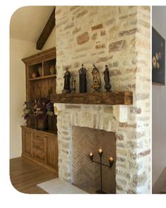 a living room with a stone fireplace and wooden shelves