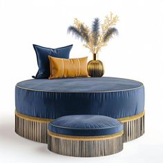 a blue round couch with gold trimmings and pillows on the bottom, sitting next to a plant