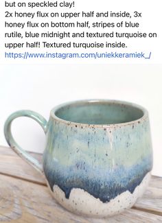 a blue and white mug sitting on top of a wooden table