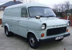 an old white van parked in a driveway