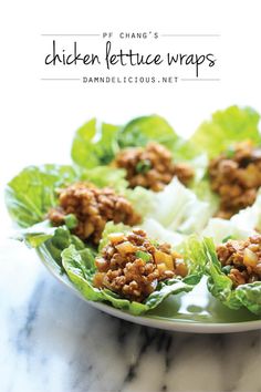 lettuce wraps filled with meat and vegetables on a marble countertop, ready to be eaten