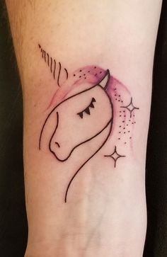 a tattoo on the arm of a woman with a horse head and stars around it