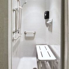 a white bathroom with a shower, sink and bathtub in the middle of it