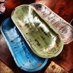 three empty boats sitting on top of a wooden table