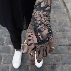 a person's hand with tattoos on it