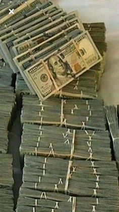 stacks of money sitting next to each other on top of a pile of paper currency