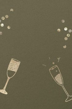 two champagne flutes with confetti falling out of them on a black background,