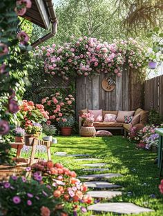 a garden with lots of pink flowers and greenery on the walls, along with an outdoor seating area