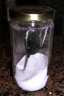 a glass jar filled with white powder on top of a counter