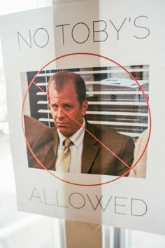 a sign with a photo of a man in a suit and tie on it that says, no tobby's allowed