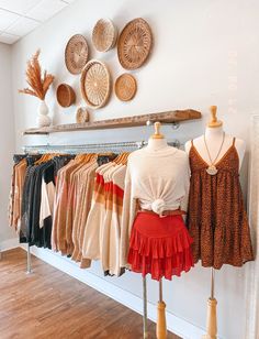 clothes are displayed on racks in a clothing store