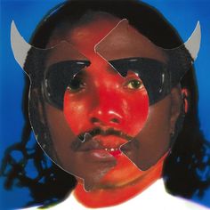 a man with two horns on his head is shown through the cut outs of another person's face