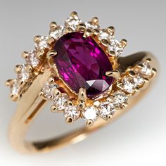 a ring with a large purple stone surrounded by smaller white and yellow diamond surrounding it