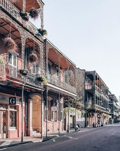 an empty street lined with tall buildings and balconies