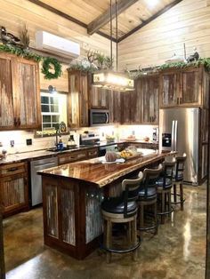 a kitchen with wooden cabinets and an island in the middle, surrounded by bar stools