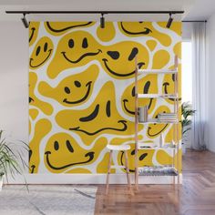 a yellow and white wall mural with smiley faces