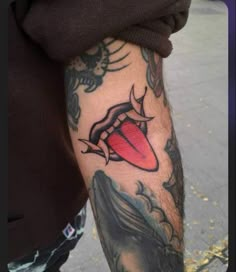 a man's arm with tattoos on it and an image of a red lips