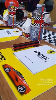 a table topped with lots of different items on top of a wooden table covered in yellow and black checkered paper