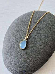 Blue Chalcedony Necklace, Cobalt Teardrop Pendant, Minimalist Blue Gold Drop Necklace, Dainty Layering Jewelry, Delicate necklace for women This simple dainty necklace features an soft cobalt blue chalcedony teardrop set in texturized bezel in gold filled. This framed stone pendant is suspended from a delicate 14k gold filled chain. This necklace is simply perfect for everyday wear and is perfect for layering with other pieces in your collection. About this Necklace: - Gemstone: Cobalt Chalcedon Sapphire Teardrop Pendant Necklace, Blue Teardrop Pendant Necklace With Adjustable Chain, Blue Teardrop Necklace With Adjustable Chain, Blue Teardrop Pendant Jewelry With Adjustable Chain, Blue Teardrop Necklace With Delicate Chain, Dainty Blue Necklace With Delicate Chain, Minimalist Blue Teardrop Jewelry, Blue Teardrop Pendant Minimalist Jewelry, Blue Teardrop Minimalist Necklace