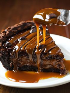 a piece of chocolate cheesecake with caramel sauce being drizzled over it