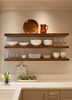 a kitchen counter with plates and bowls on it