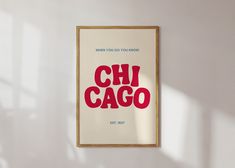 there is a poster hanging on the wall next to a window that says chi cago