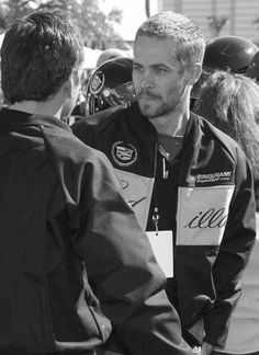 a man shaking hands with another man in front of him at an outdoor event stock photo