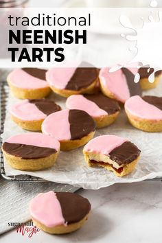 there are some cookies with pink frosting on them