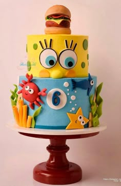 a three tiered cake decorated with cartoon characters