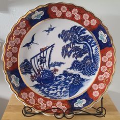 a blue and red plate with a boat on it