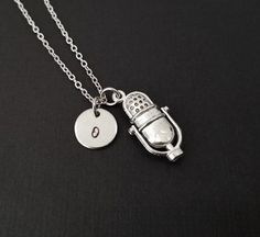 Personalized Silver Radio DJ Microphone Necklace!  A detailed three dimensional microphone charm on a bright silver chain makes the perfect gift for you or a your favorite podcaster.The musician charm is made from zinc alloy and measures 26 mm by 13 mm.  The chain is silver plated and measures 16" or 18" with a 1" extender.  You can also personalize your necklace with a .5" silver plated disc stamped with the initial of your choice.To order your necklace WITHOUT a custom stamped initial disc, ch Microphone Necklace, Instrument Jewelry, Chef Necklace, Christian Necklace, Music Jewelry, Necklace Initial, Birthstone Charms, Necklace Personalized, Musical Instrument