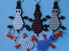 four beaded keychains in different colors and shapes on a blue background,