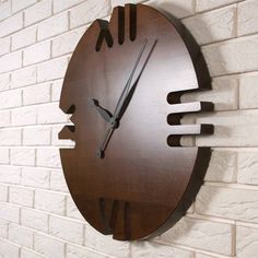 a clock mounted to the side of a white brick wall