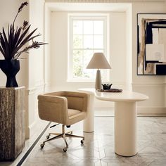 a table with two chairs and a lamp in a room