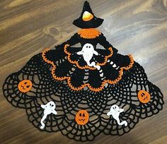 a crocheted doily with halloween decorations on it