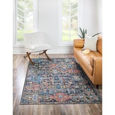 a living room with a couch, chair and rug