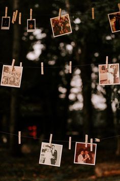 several photos hanging from clothes pins on a string in front of some trees with pictures pinned to them