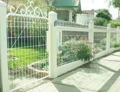 a white picket fence in front of a house