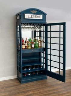 a blue phone booth with liquor bottles in it