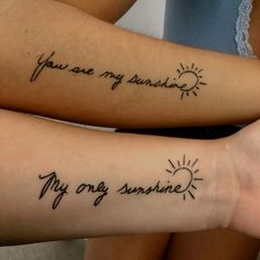 two people with tattoos on their arms that say you are my sunshine